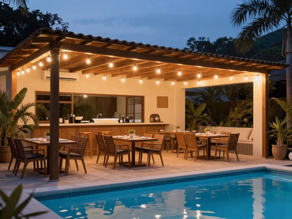 Outdoor dining area by a pool with string lights overhead